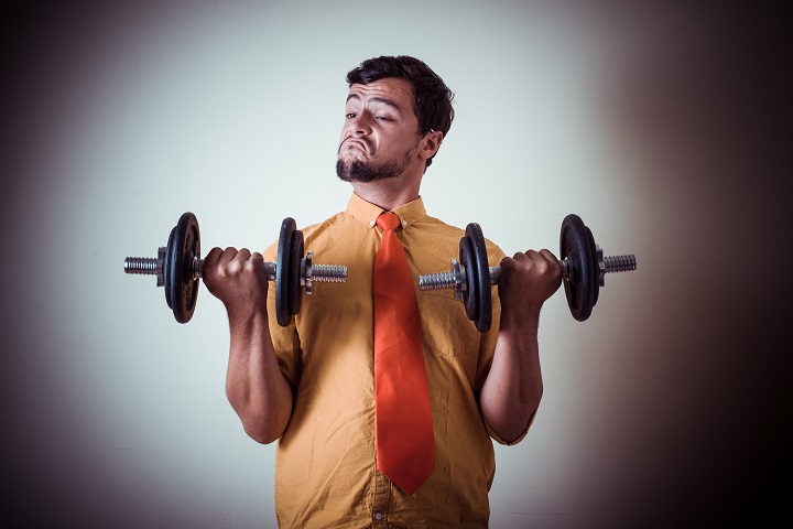 funny crazy young man weightlifting on gray background