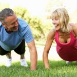 Senior Couple Exercising In Park