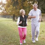 Senior Couple Power Walking In The Park