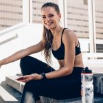 Sports woman relaxing after working out outdoors